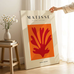 Matisse Art Prints - Red Leaf Abstract Orange Square Poster displayed in modern gallery setting with flowers.