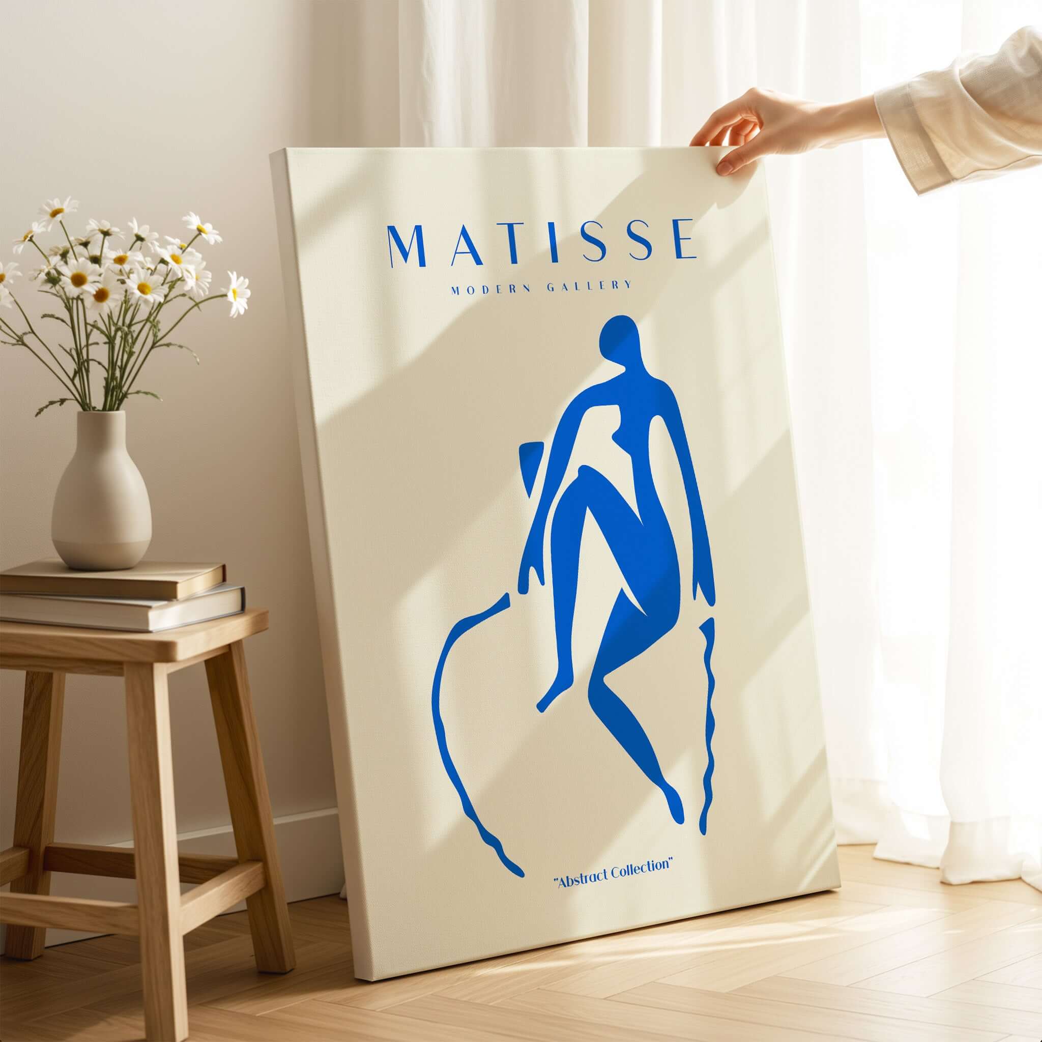 Matisse Art Prints -  Blue Nude Seated Figure Poster displayed in a bright room with flowers and wooden furniture.