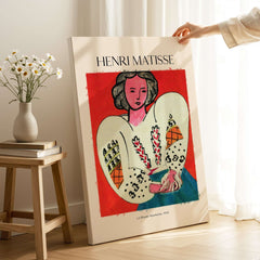 Matisse Poster - La Blouse Roumaine 1940 Famous Art Print displayed with a decorative flower vase in an elegant setting.