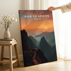 Hand holding Pico do Arieiro Madeira travel poster print with mountain sunset in modern room
