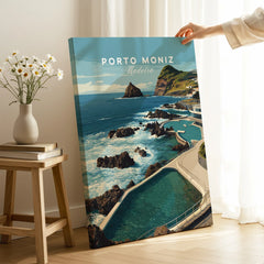 Hand holding Porto Moniz Madeira travel poster canvas print in modern home interior setting