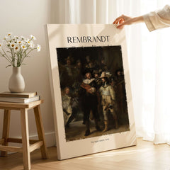 Rembrandt The Night Watch 1642 Famous Dutch Master Painting Art Print Poster displayed in a cozy interior setting.