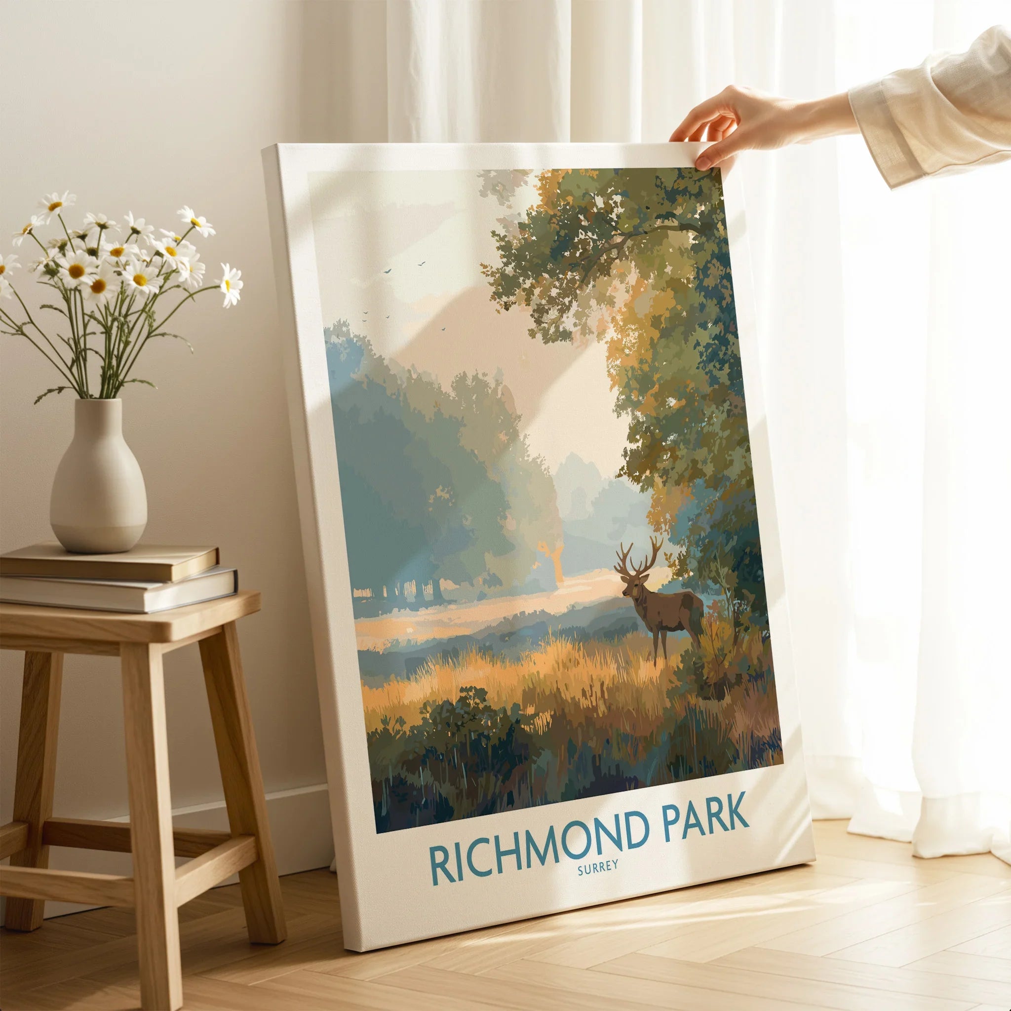 Richmond Park canvas art print with deer, propped in bright modern room next to vase and books
