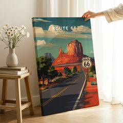Hand holding Route 66 canvas wall art poster with desert landscape in a modern room setting