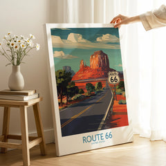 Person holding Route 66 travel poster print with desert landscape and highway decor