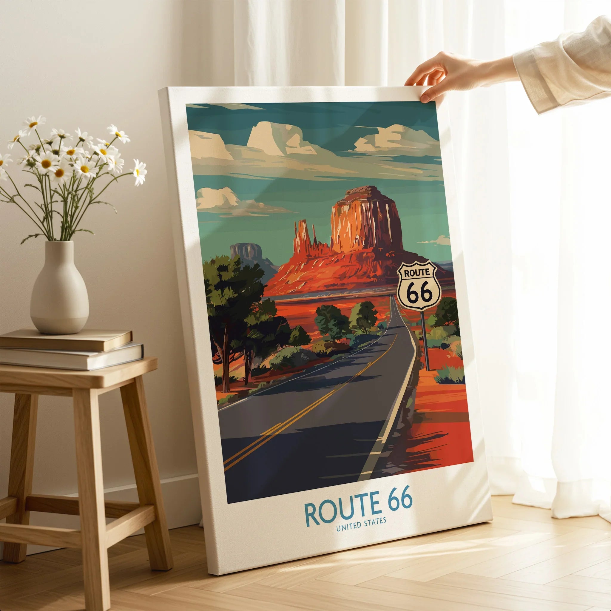 Person holding Route 66 travel poster print with desert landscape and highway decor