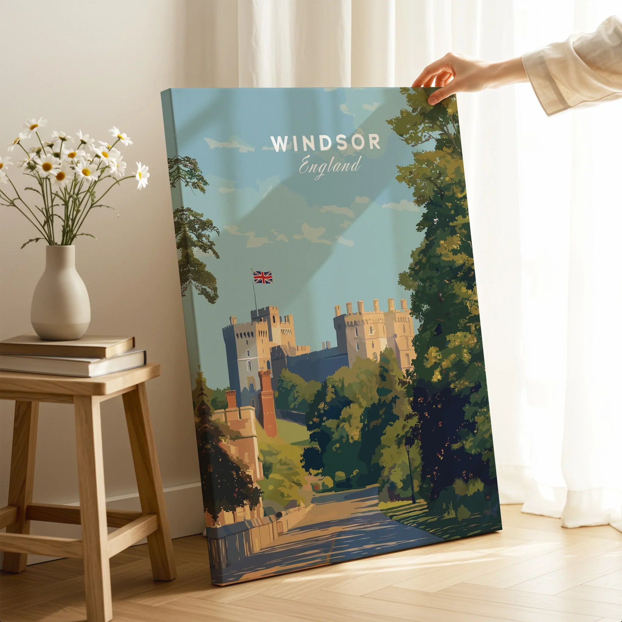 Hand holding Windsor England travel poster canvas print in cozy home decor setting