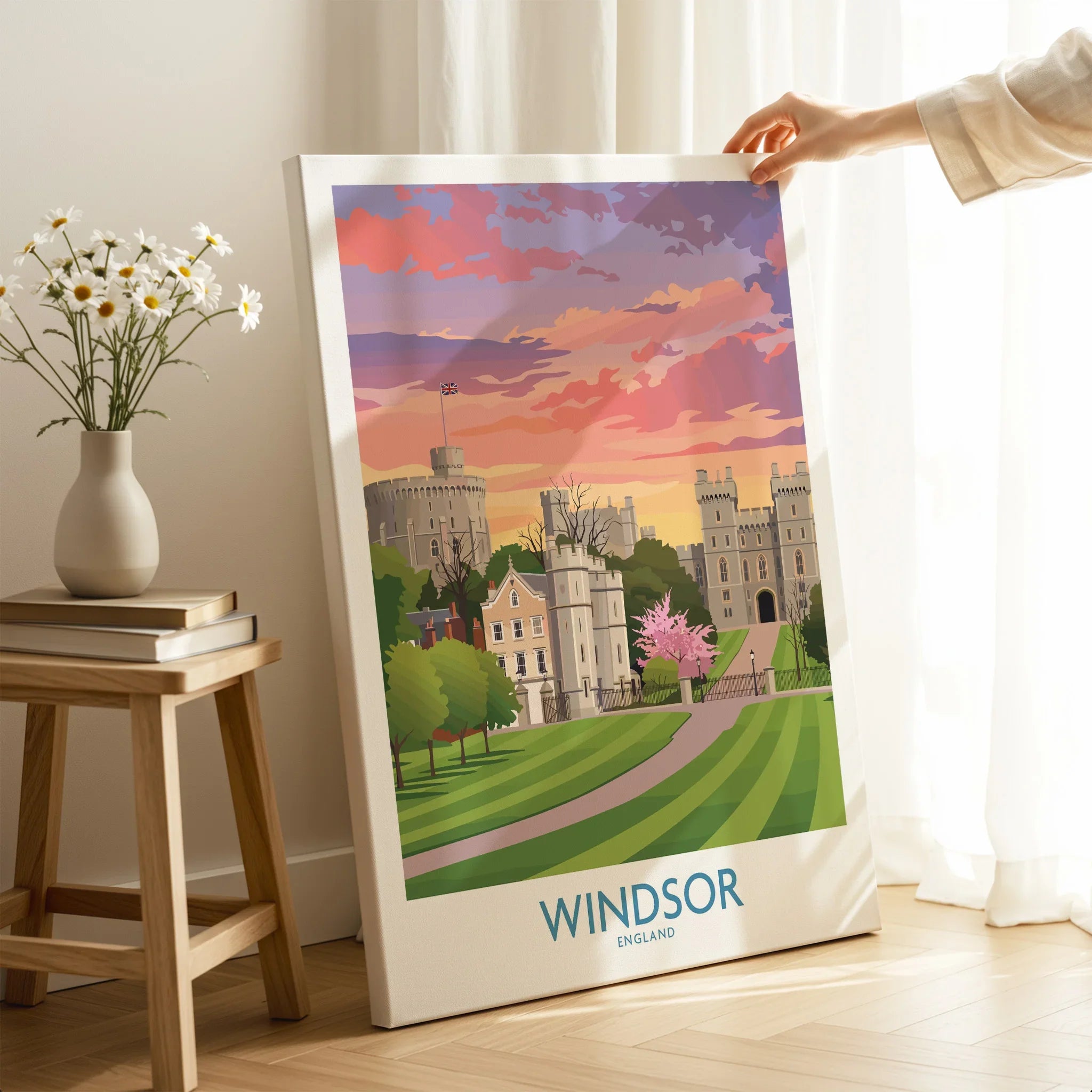 Hand holding Windsor England canvas print featuring colorful skyline in modern home decor setting.