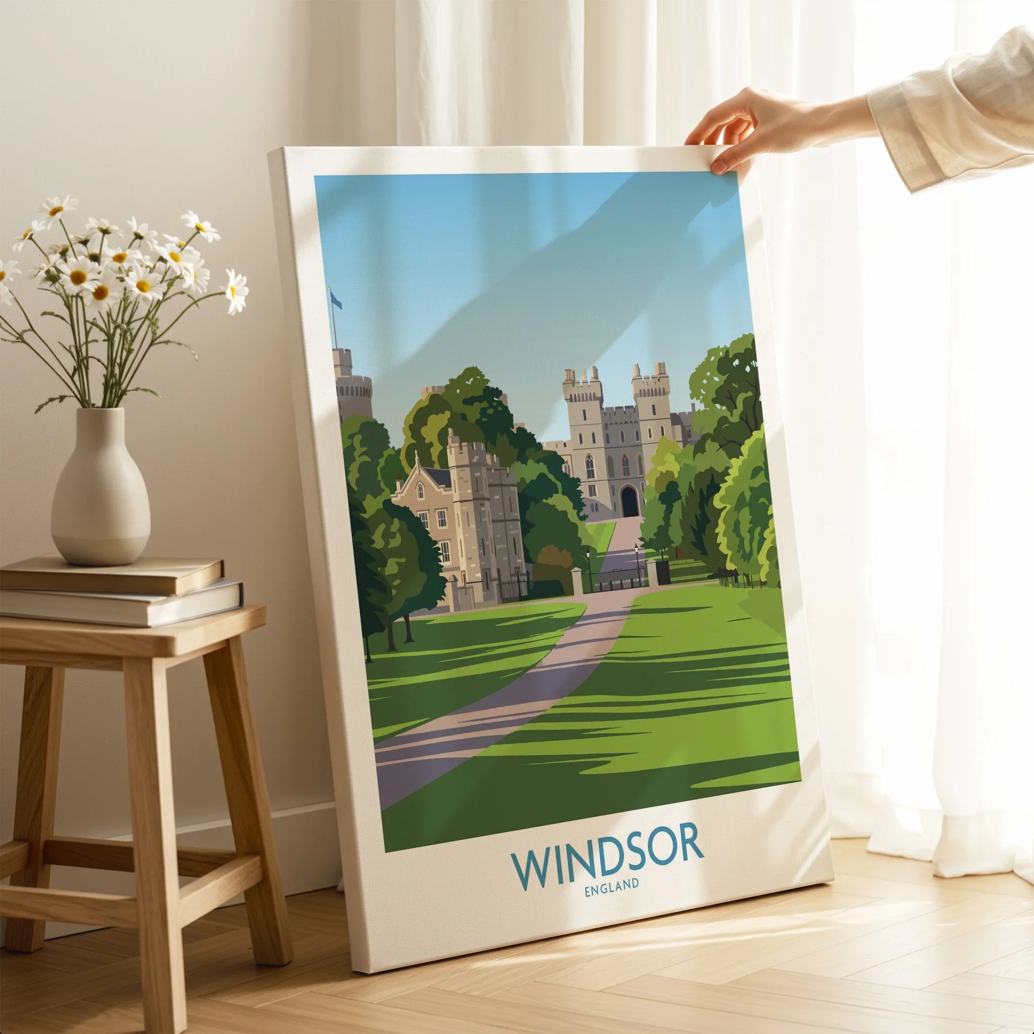 Hand holding Windsor England travel poster canvas print in modern home decor setting