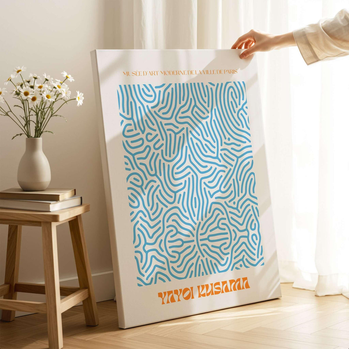 Yayoi Kusama Blue Infinity Net Pattern Abstract Art Print Paris Exhibition Poster displayed on a table with floral decor.