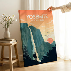 Hand holding Yosemite National Park travel poster print with mountains and sunset in room