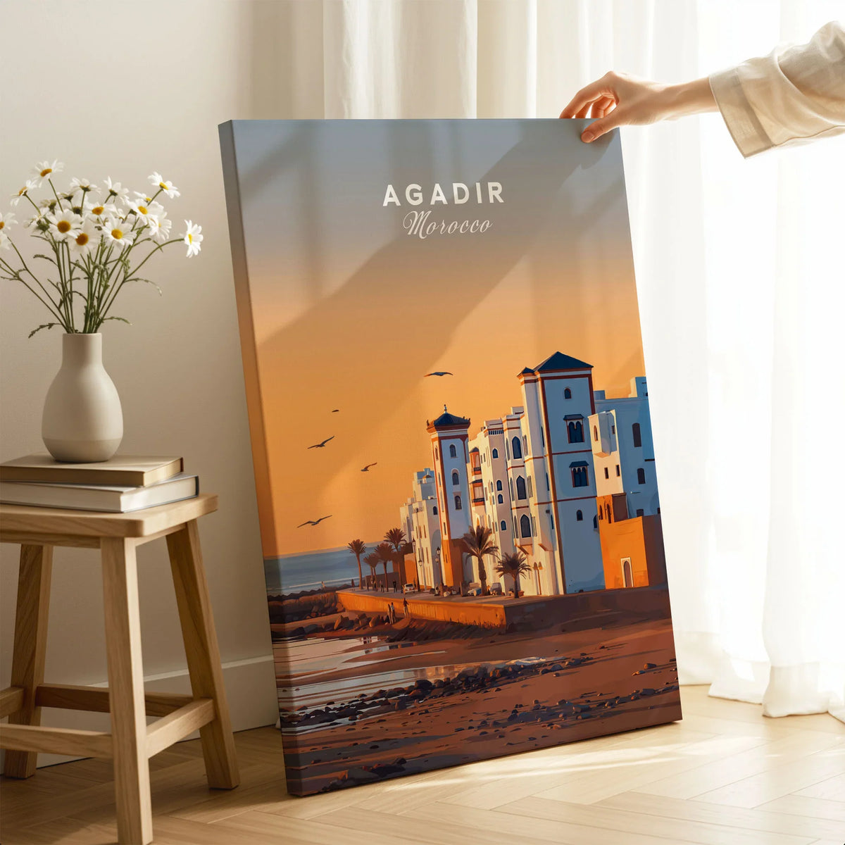 Agadir Travel Poster – Morocco Beach Print on stretched canvas with mirror-wrap edges, held by hand in a room setting