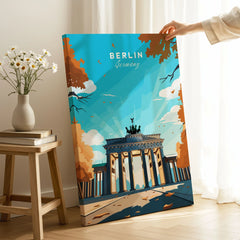 Berlin Poster Blue Sky on stretched canvas with mirror-wrap edges, held by hand in a room setting