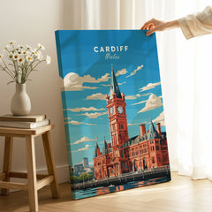 Cardiff Travel Poster on stretched canvas with mirror-wrap edges, held by hand in a room setting