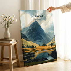 Glencoe Travel Print on stretched canvas with mirror-wrap edges, held by hand in a room setting