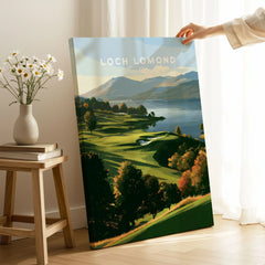 Loch Lomond Scotland Autumn Lochside Travel Poster — autumn slopes rolling down to Loch Lomond with Highland hills beyond, shown as canvas print mirror edge hand holding room setting