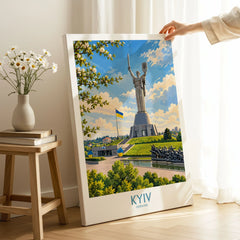 Kyiv Ukraine Spring Blossom Wall Art — the Motherland Monument under spring blossom with the Ukrainian flag flying, shown as canvas print mirror edge hand holding room setting