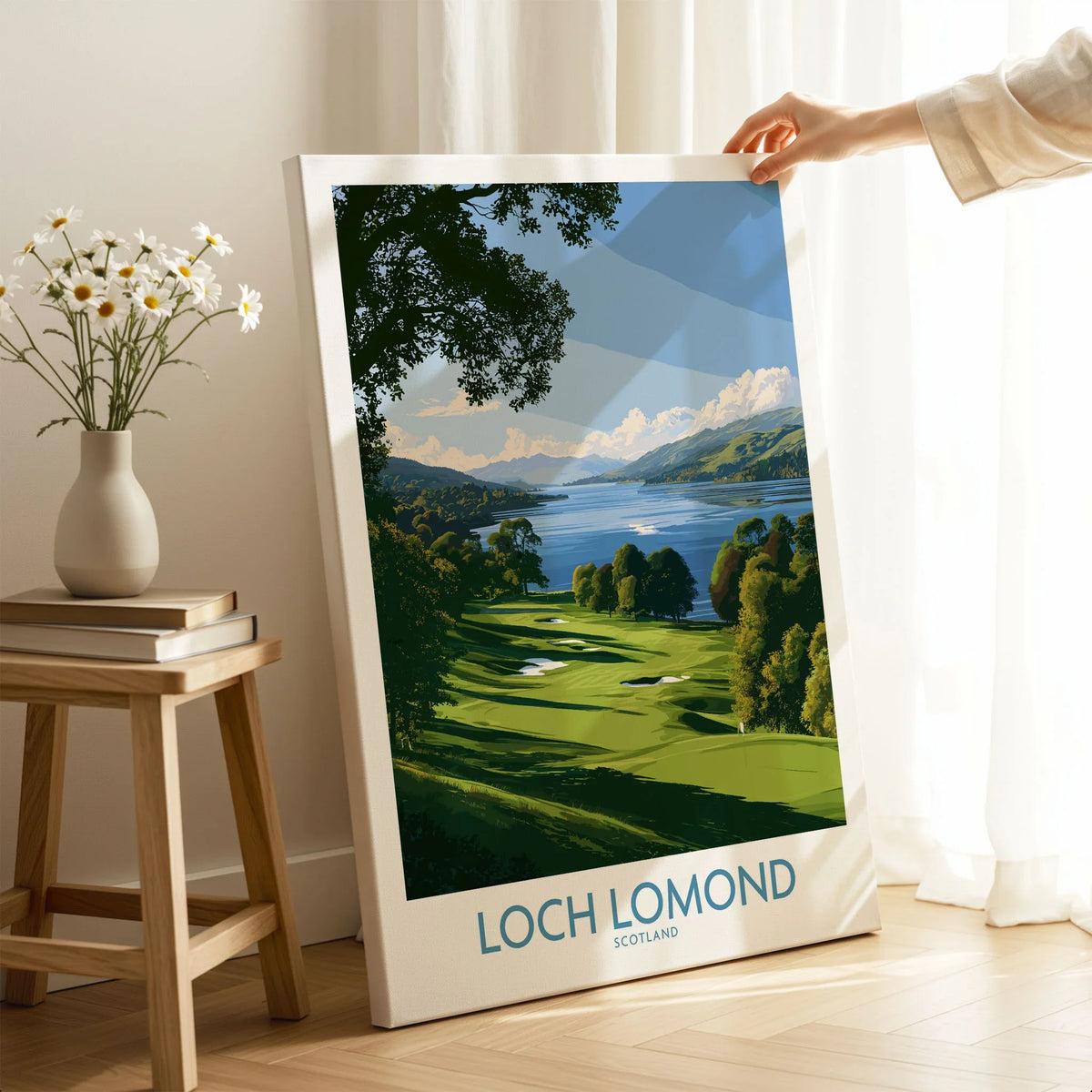 Loch Lomond Scotland Lochside Meadow Wall Art — a sunlit grassy shoreline running down to Loch Lomond under old oaks, shown as canvas print mirror edge hand holding room setting