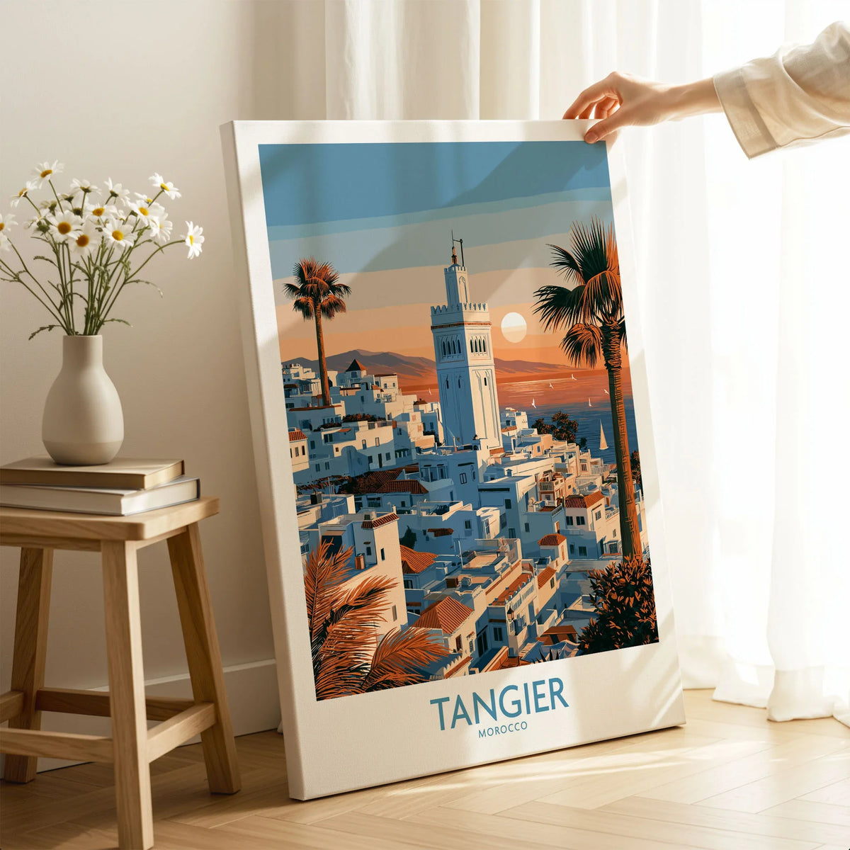 Tangier Morocco Sailboats and Rooftops Wall Art — Tangier medina rooftops and a minaret above a bay dotted with sails, shown as canvas print mirror edge hand holding room setting