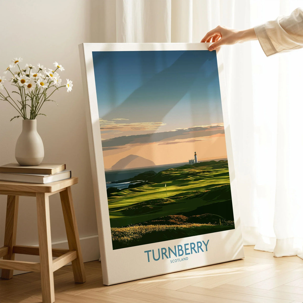 Turnberry Scotland Ayrshire Dusk Wall Art — Ailsa Craig and the white lighthouse across rolling coastal turf at dusk, shown as canvas print mirror edge hand holding room setting