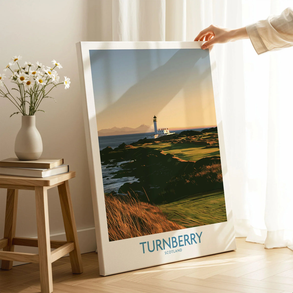 Turnberry Scotland Rocky Shore Wall Art — the Turnberry lighthouse above a rocky shore with the Arran hills beyond, shown as canvas print mirror edge hand holding room setting