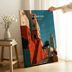 Tangier Morocco Kasbah Steps Travel Poster — coral kasbah steps climbing towards a minaret under a crescent moon, shown as canvas print mirror edge hand holding room setting