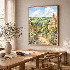 Cotswolds stone cottages and church tower watercolour art print in a natural wood frame in a dining room