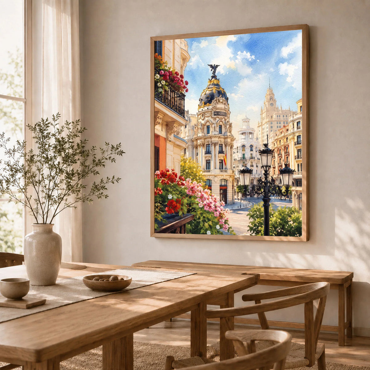 Madrid Metropolis building on Gran Vía watercolour art print in a natural wood frame in a dining room