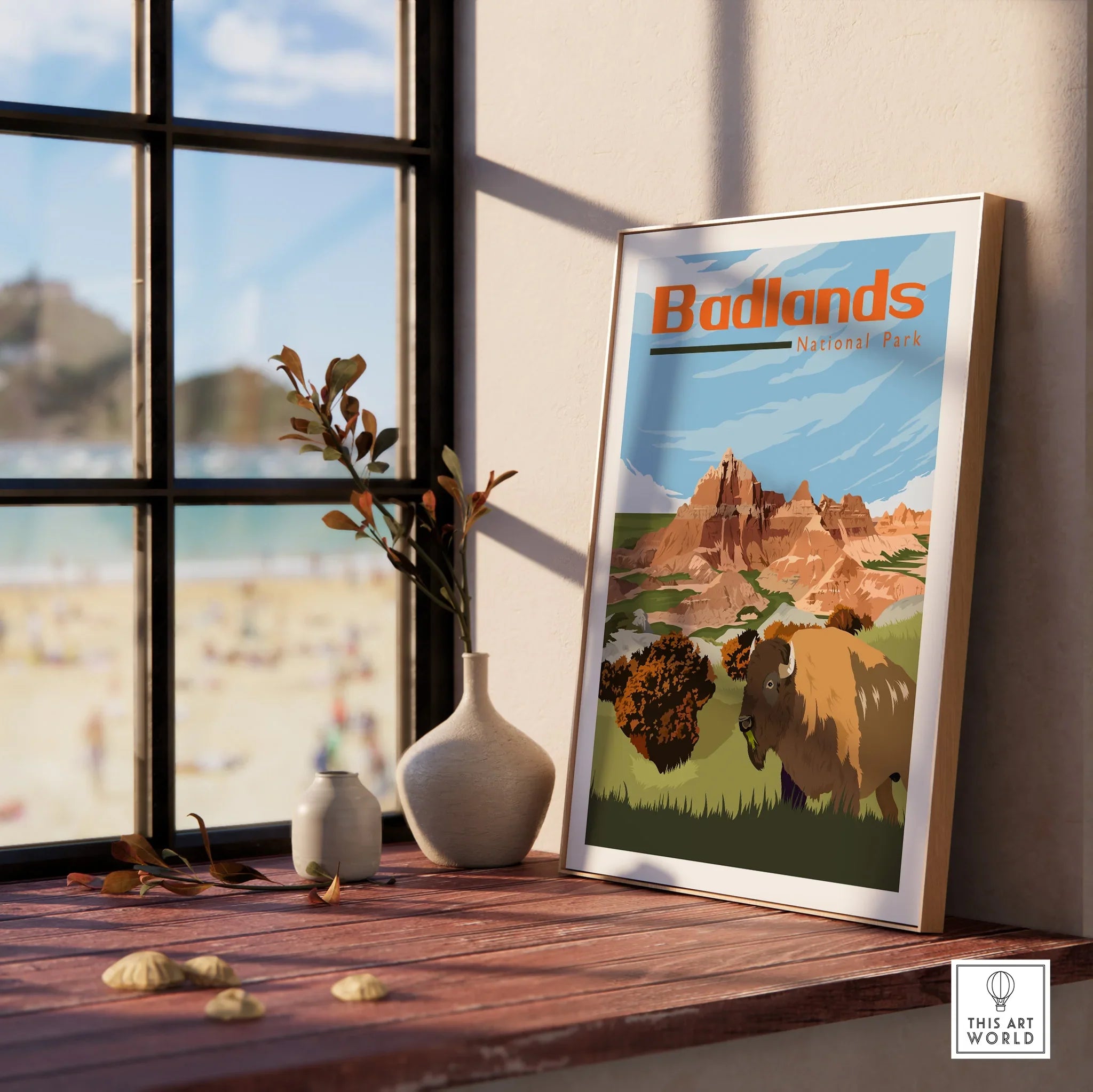 Framed Badlands National Park print with bison, set on sunlit windowsill with vases.