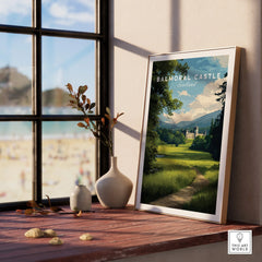 Framed Balmoral Castle Scotland travel poster on a window sill with vases and beach view
