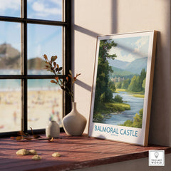 Framed Balmoral Castle travel art print with river and mountain view on a window sill