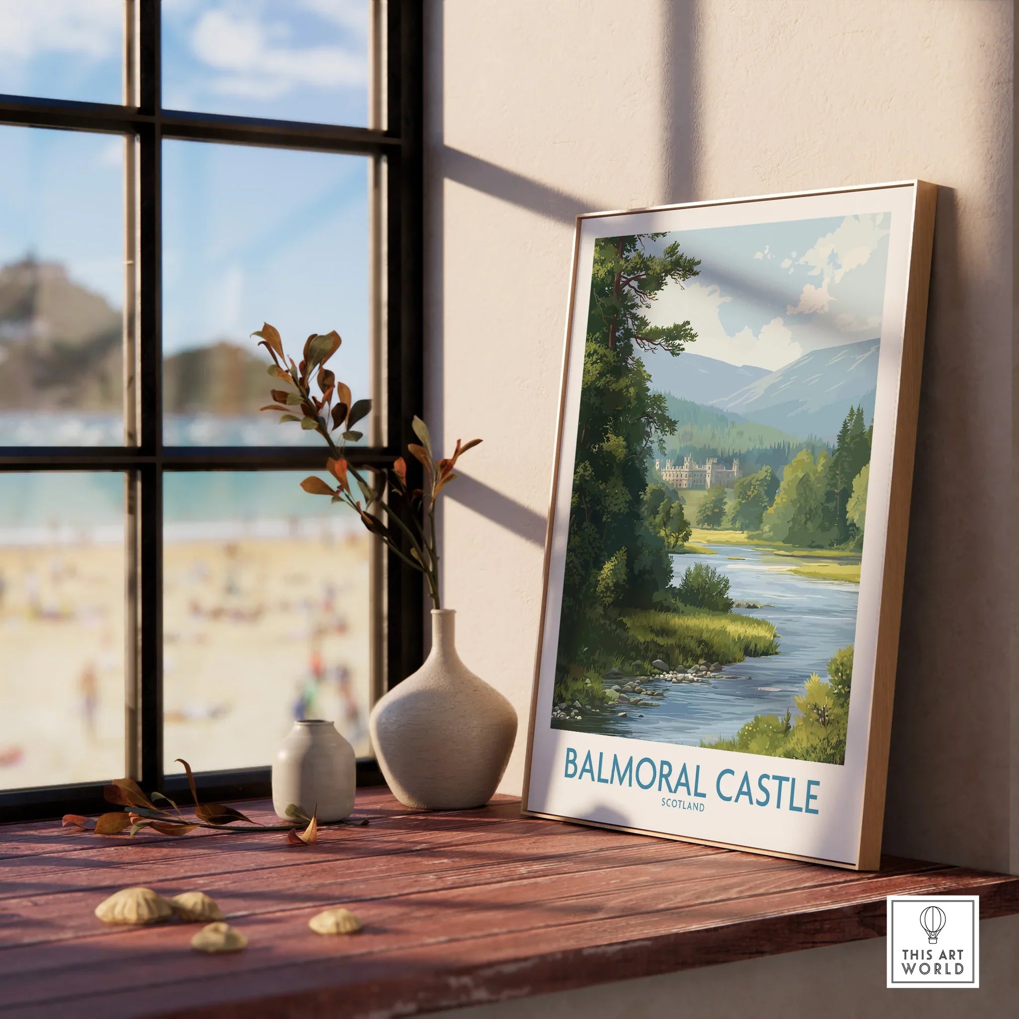 Framed Balmoral Castle travel art print with river and mountain view on a window sill