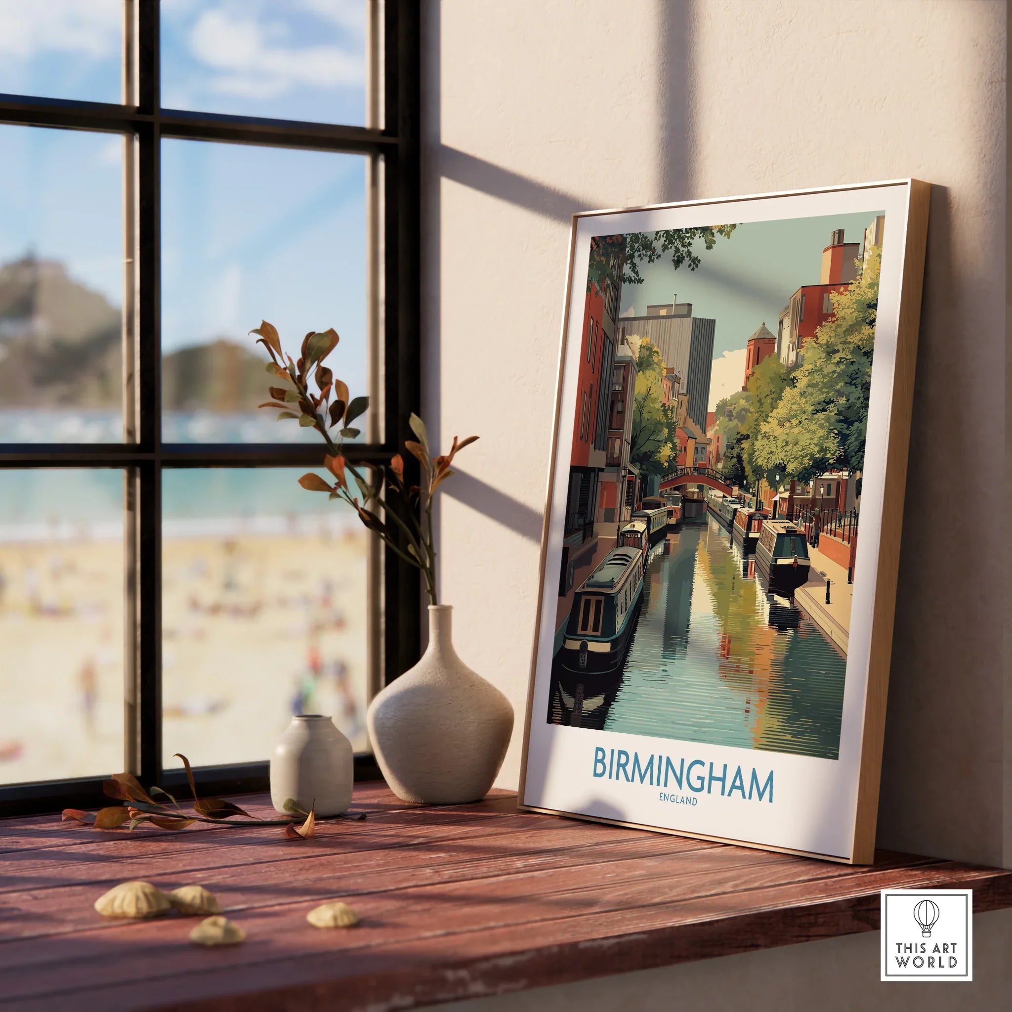 Framed Birmingham canal cityscape art print on windowsill with natural wood frame