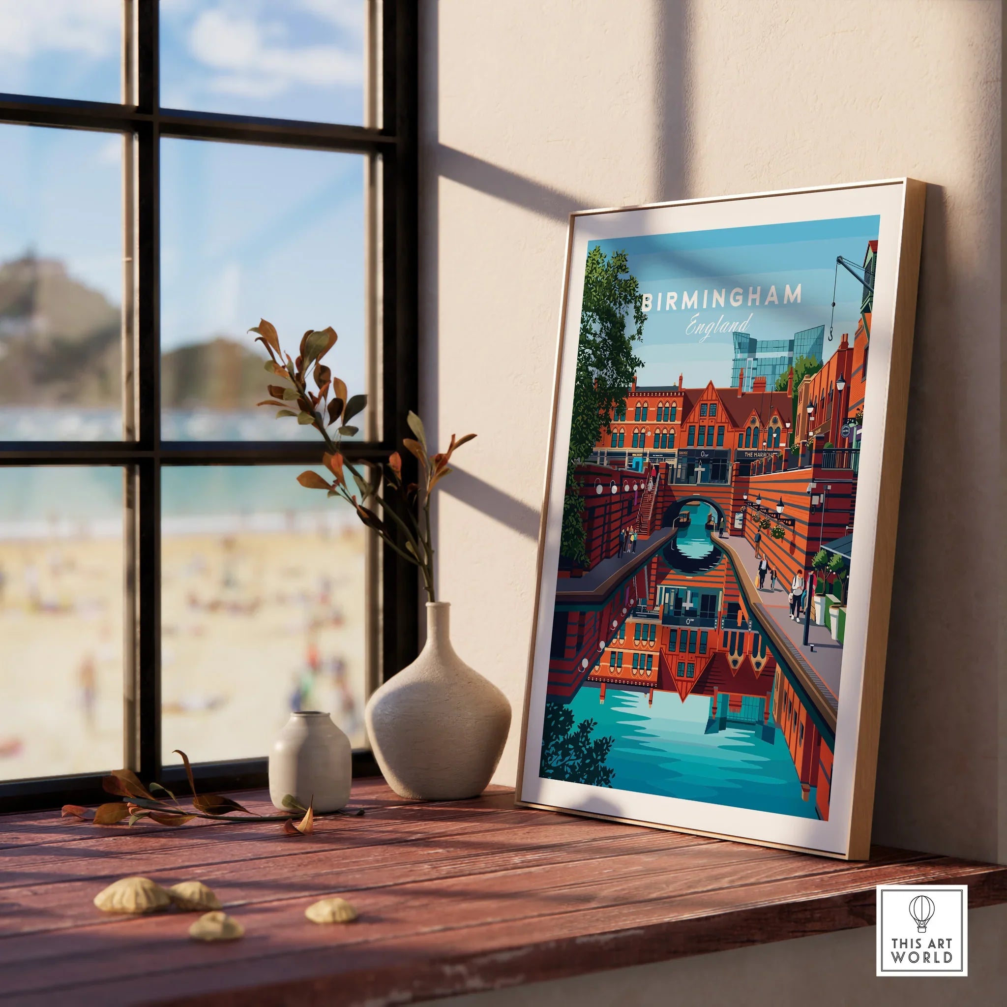 Framed Birmingham travel poster on windowsill with vases and beach view in background