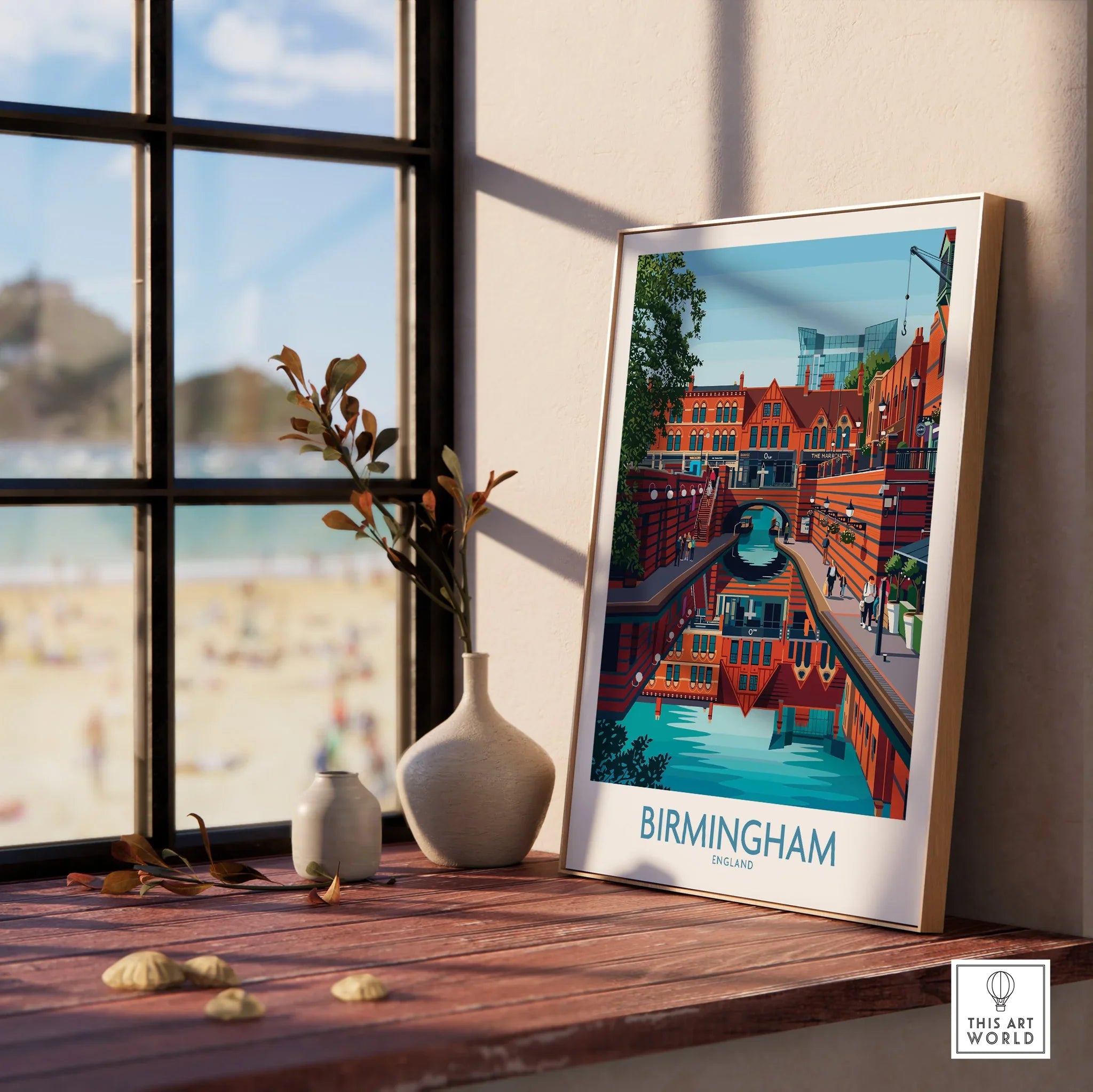 Framed Birmingham city skyline art print on windowsill with vases and beach view outside.