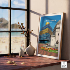 Framed Birmingham England cityscape art print on wooden windowsill with vases and natural light.