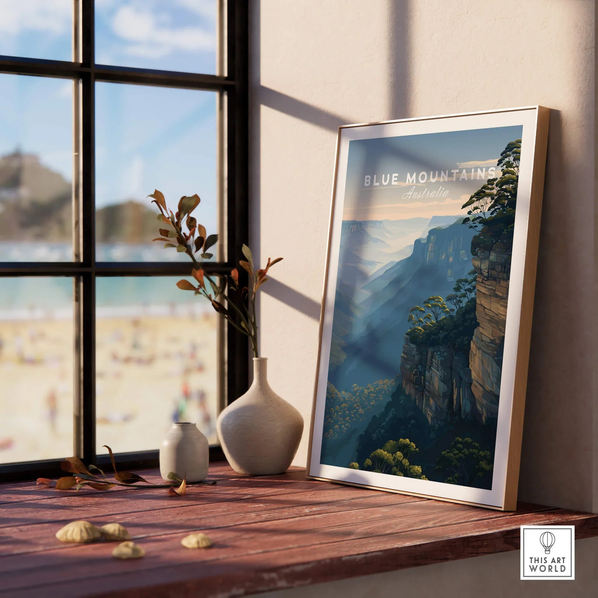 Framed Blue Mountains Australia travel poster on a windowsill with vases, beach view outside