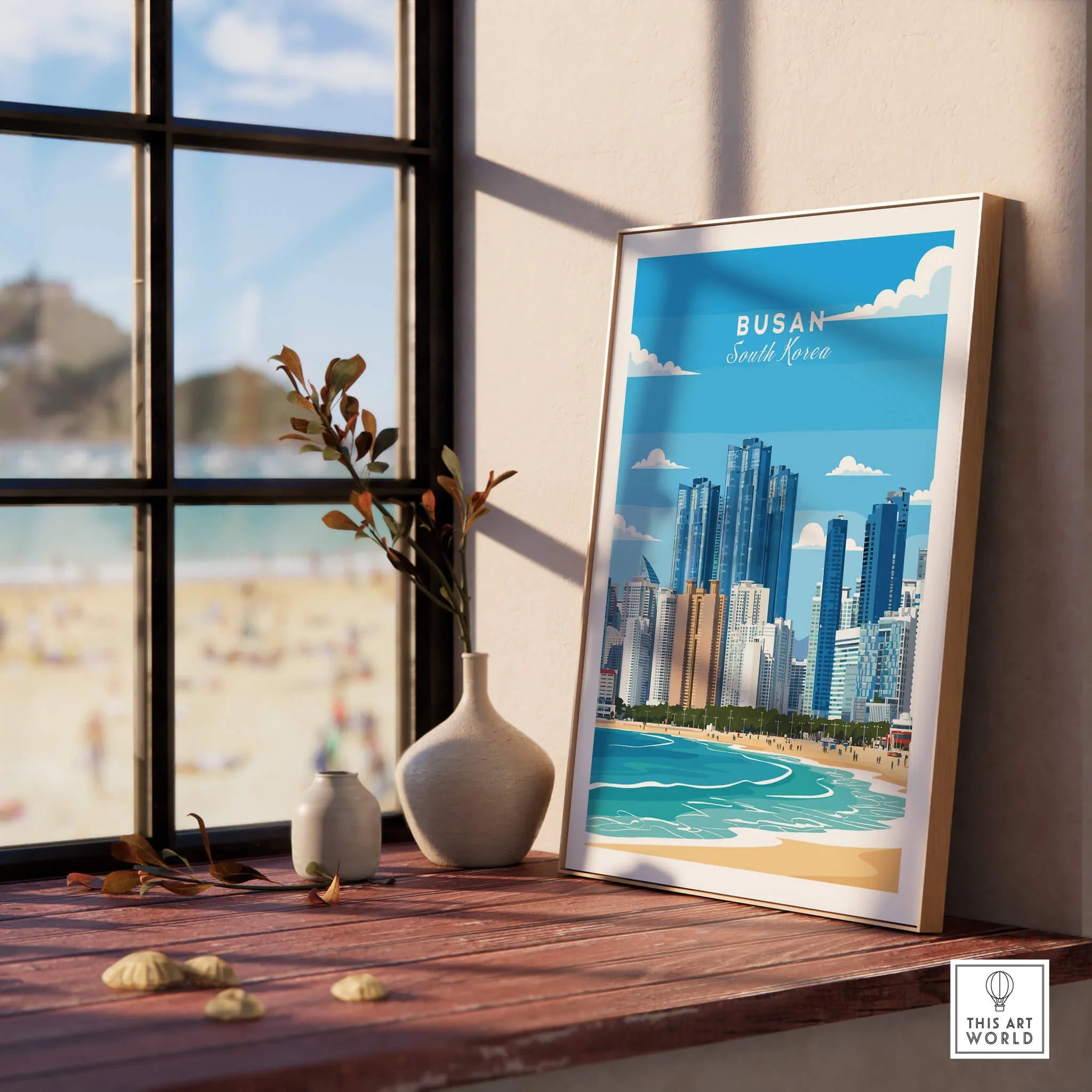 Framed Busan South Korea city skyline art print by window, beach scene reflected.