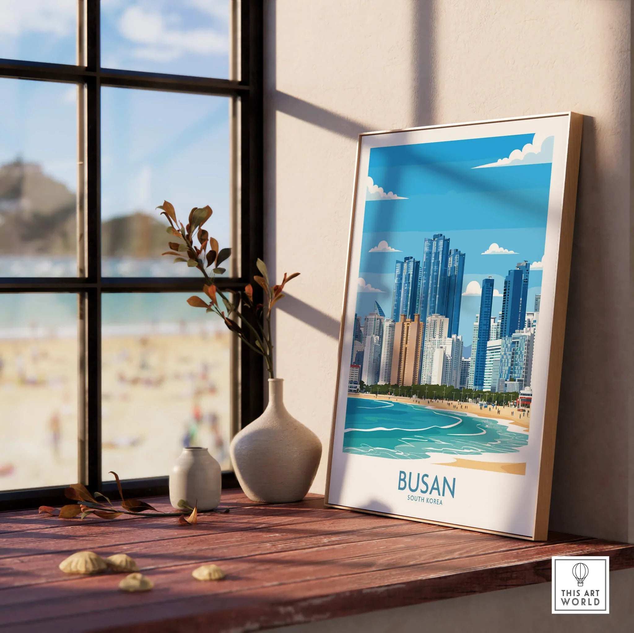 Framed Busan skyline wall art print on window ledge with beach view and decorative vases