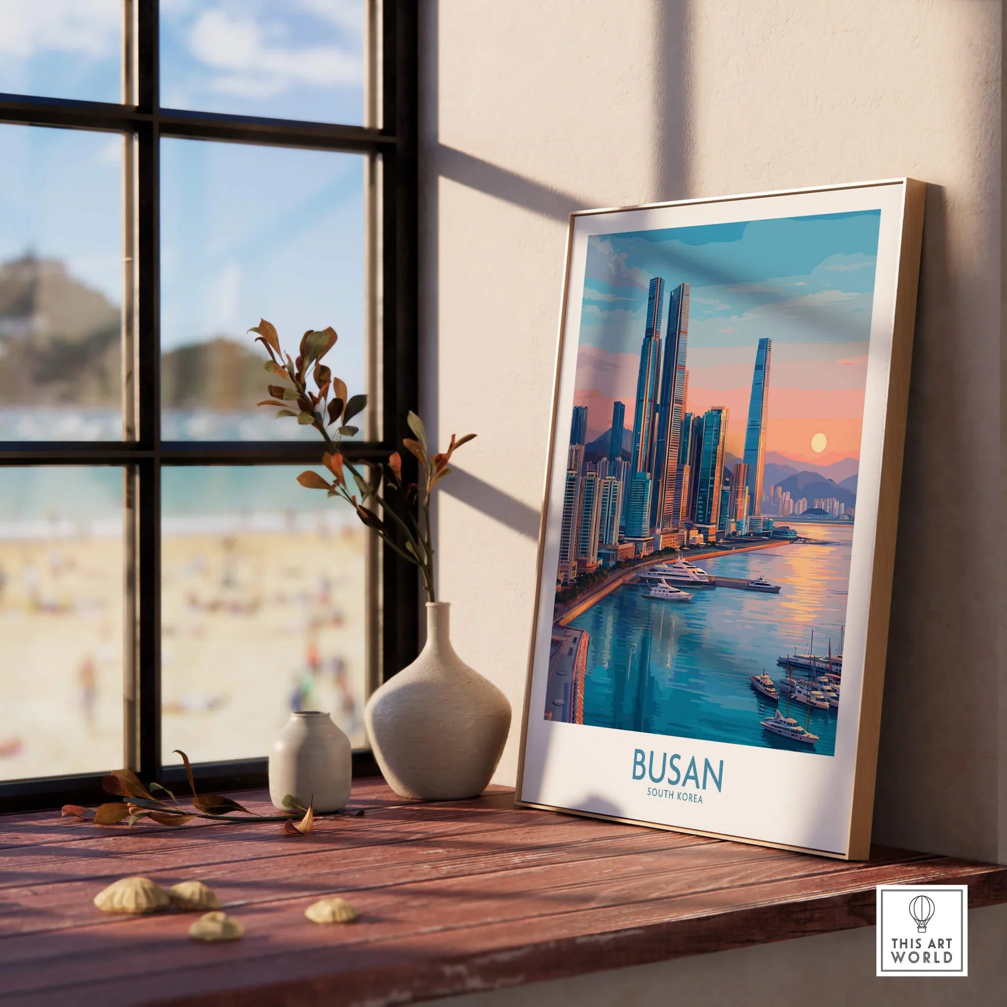 Framed Busan city skyline print on wooden windowsill, beach scene outside window