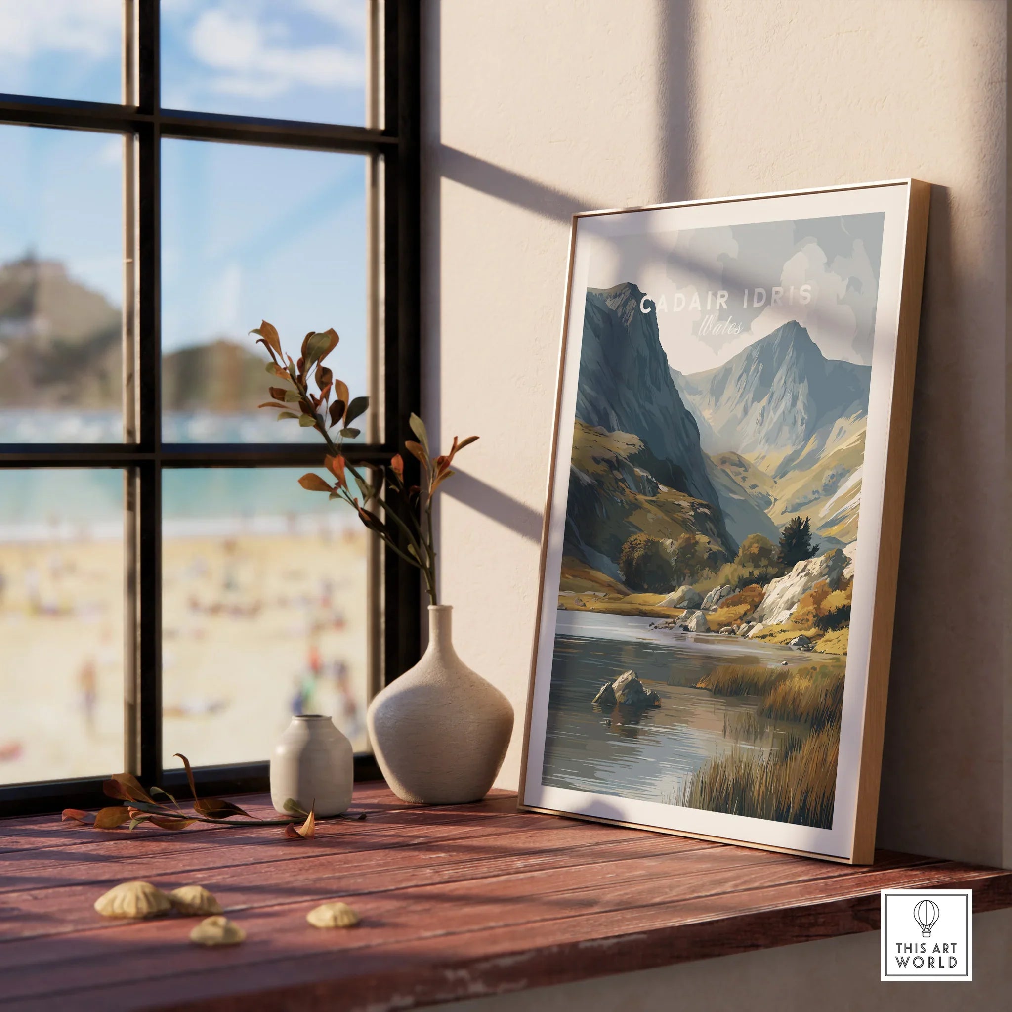 Framed Cadair Idris Wales travel poster on windowsill with vases and scenic mountain artwork