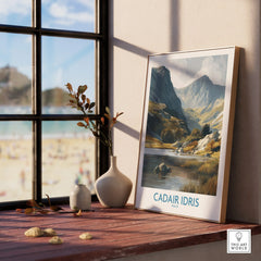 Framed Cadair Idris Wales travel poster on window ledge with natural light and vases