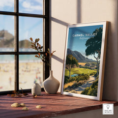 Framed Carmel Valley California travel poster on windowsill with natural light and vases.