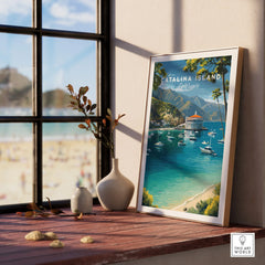 Framed Catalina Island travel poster on windowsill, beach view outside, nautical wall art