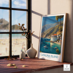 Framed Catalina Island art print on windowsill with beach view and decorative vases