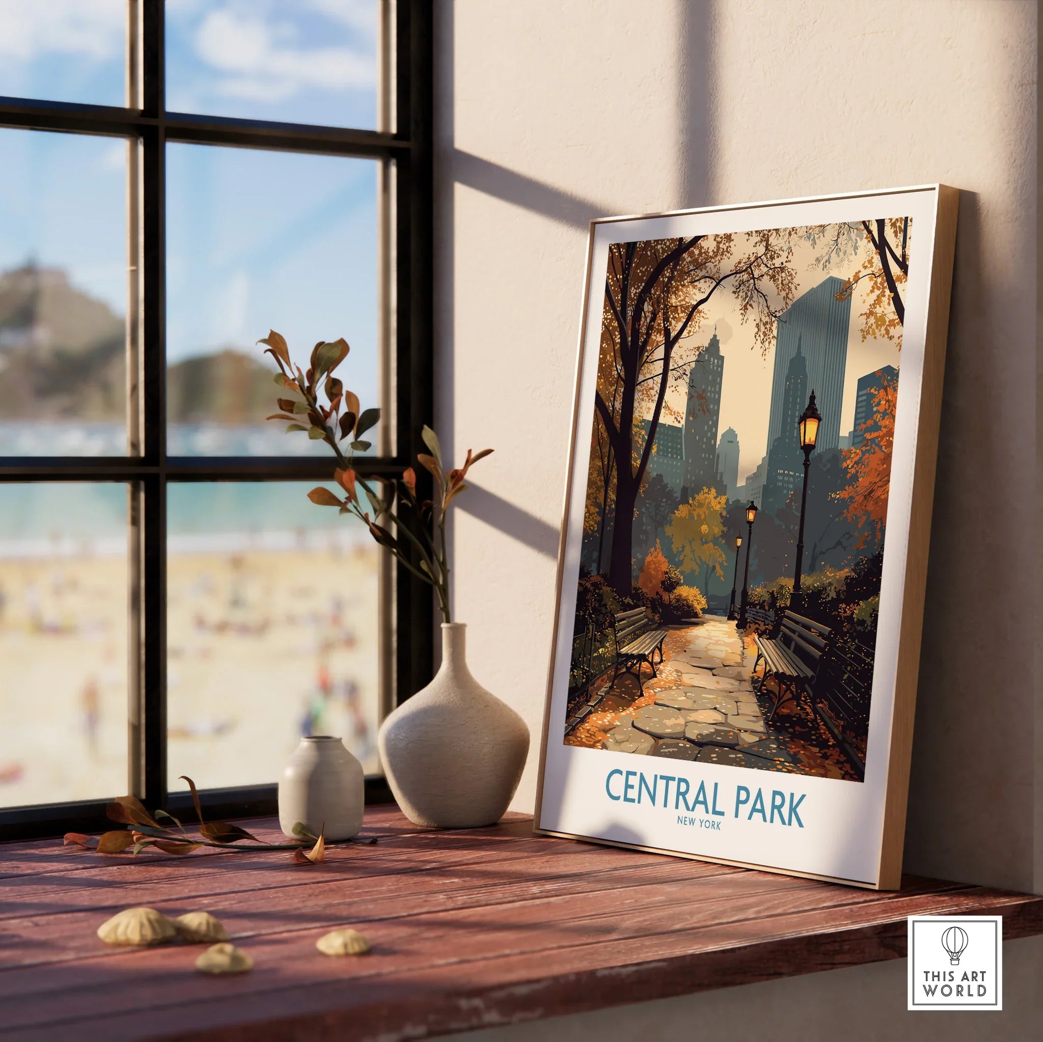 Framed Central Park print with autumn city skyline on a wooden windowsill, cozy home decor