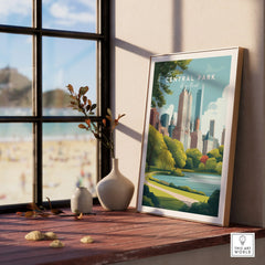 Framed Central Park New York art print on window ledge, with vases and natural light.