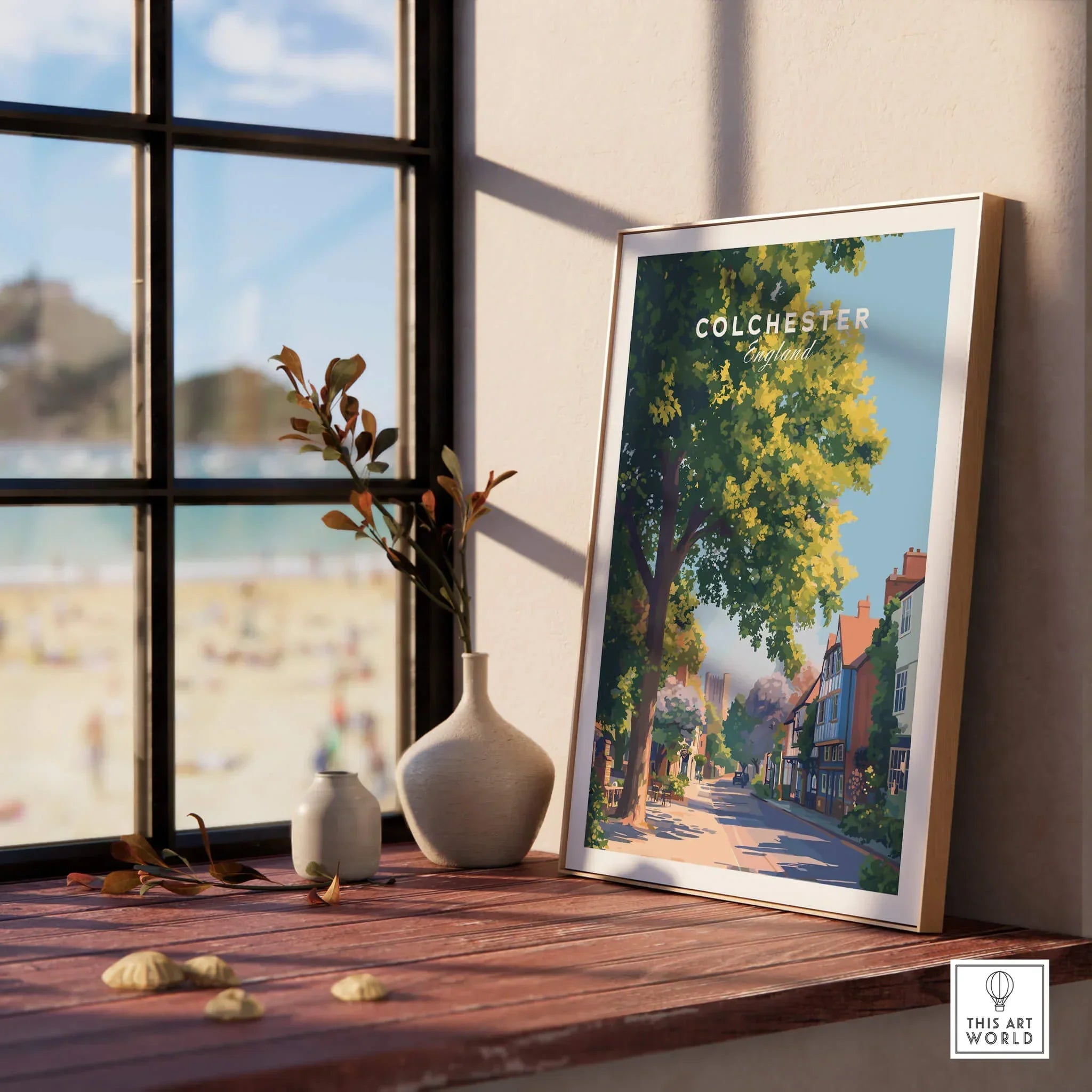 Colchester England travel poster in natural wood frame on windowsill with vases and beach view