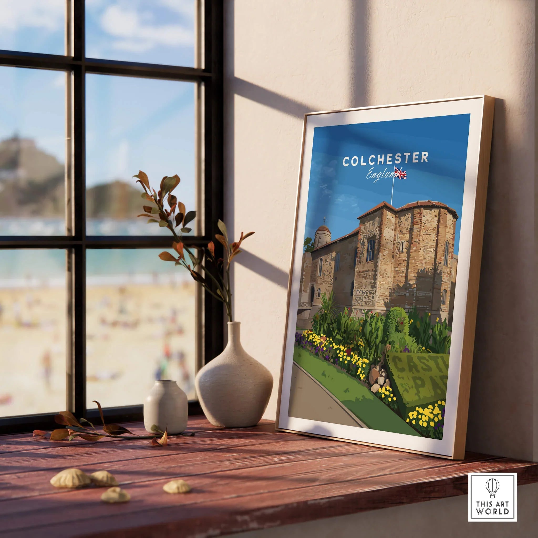 Colchester England travel poster in natural wood frame on windowsill with vases and beach view