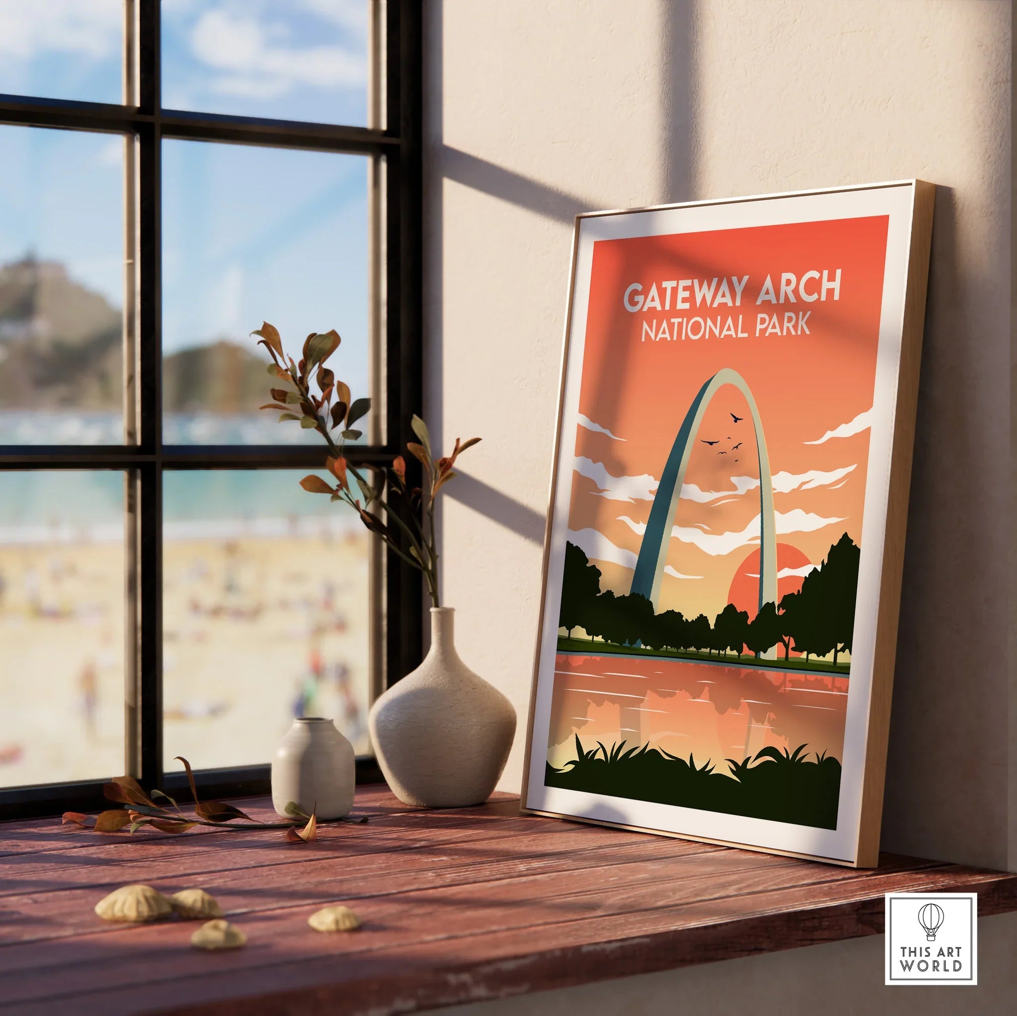 Framed Gateway Arch National Park print on windowsill with vases and sunset view